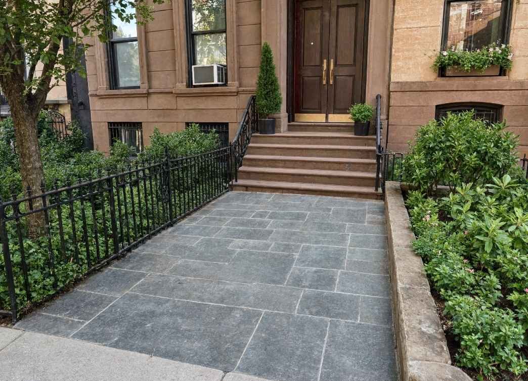 Stamped concrete walkway with ashlar slate pattern in front of a New York City home